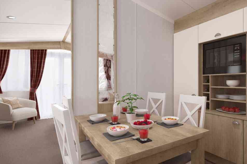 Contemporary dining area set for four with food and juice, adjacent to a comfortable living room with sofa and curtains.