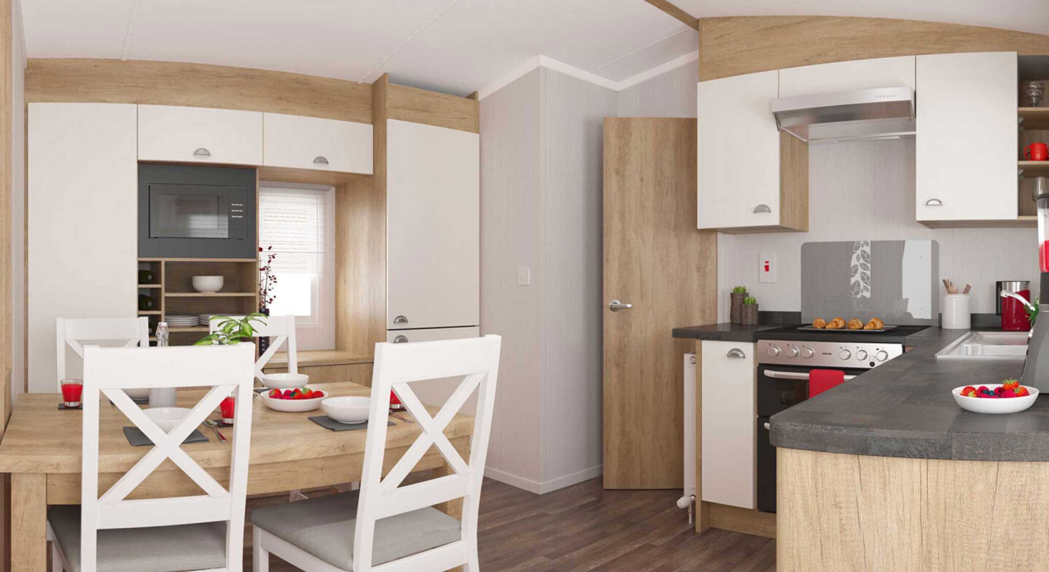 Stylish kitchen with wooden accents, light cupboards, and a dining table with white chairs set for a meal, exuding warmth and comfort.